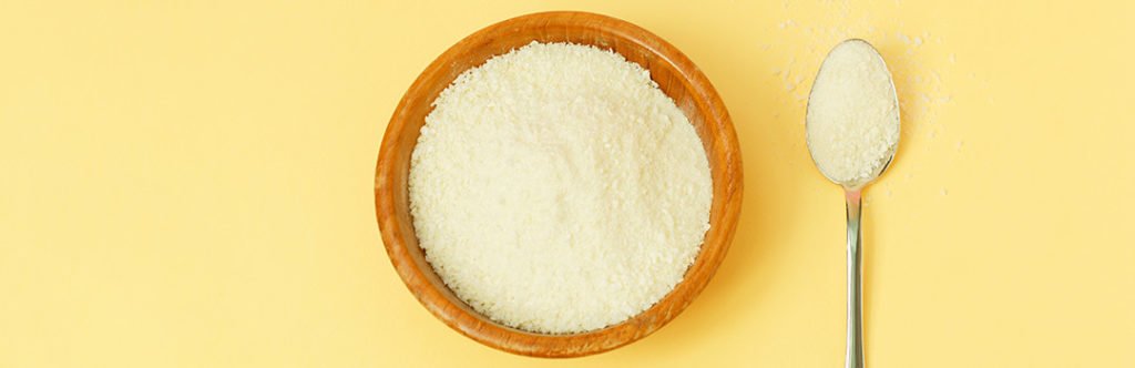 Bowel and spoon with lactose-free collagen protein powder