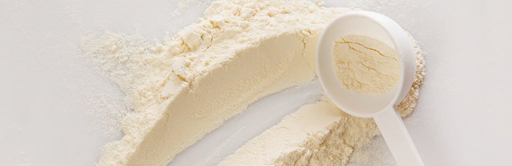White scoop and lactose-free protein powder